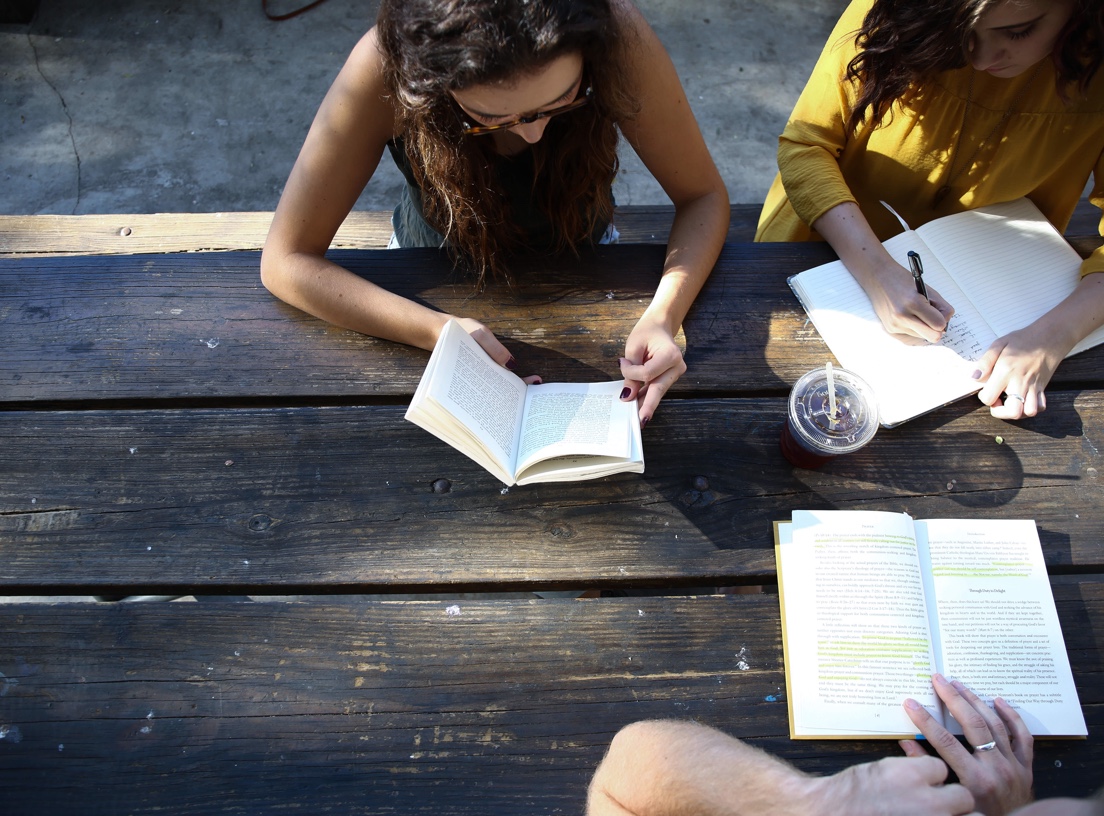 Students studying on wooden table.