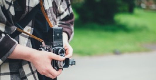 man holding a vintage camera