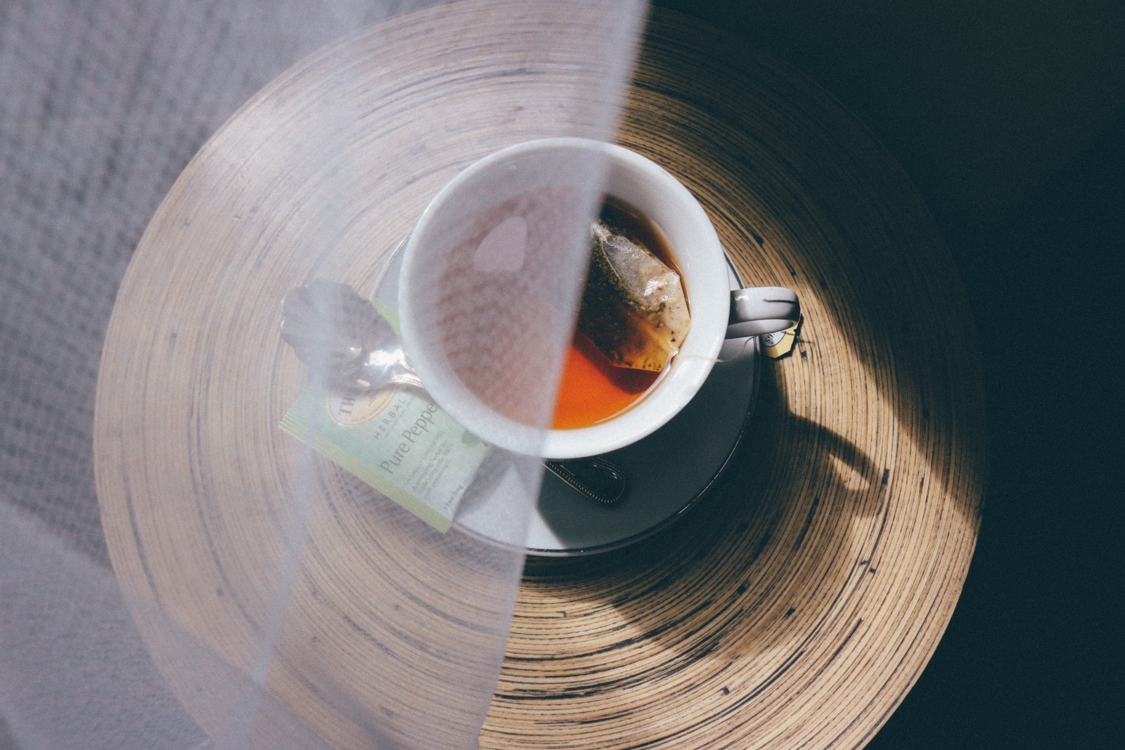 Tea cup with tea bag seeping in it